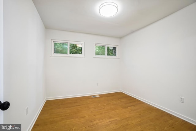 spare room featuring hardwood / wood-style flooring