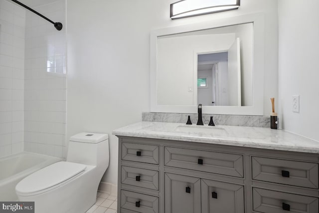 full bathroom featuring toilet, tiled shower / bath, vanity, and tile patterned flooring