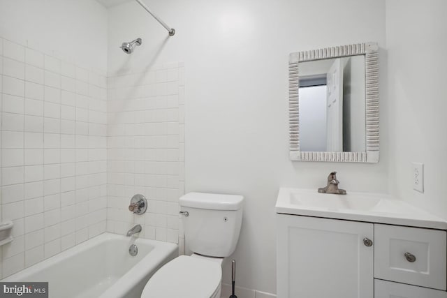 full bathroom with toilet, tiled shower / bath combo, and vanity