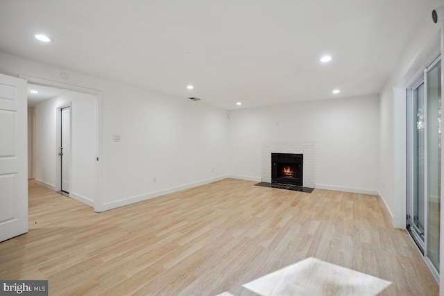 unfurnished living room featuring a fireplace and light wood-type flooring