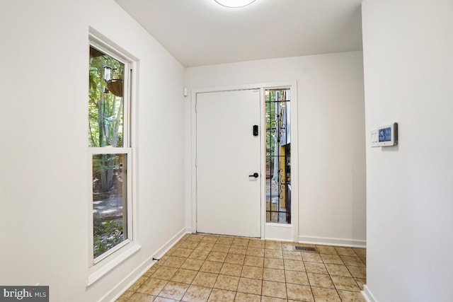 foyer with a healthy amount of sunlight and light tile patterned floors