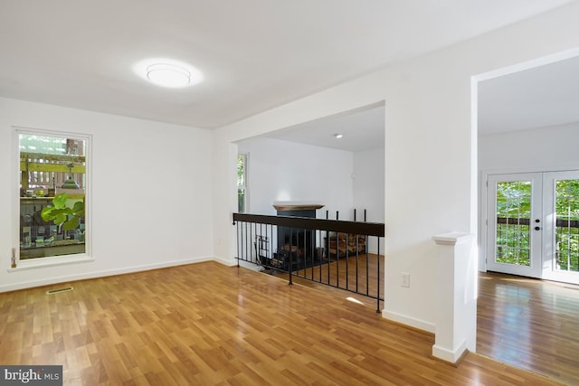 unfurnished room with light hardwood / wood-style floors and french doors