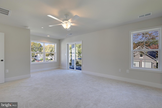 unfurnished room featuring light colored carpet and ceiling fan