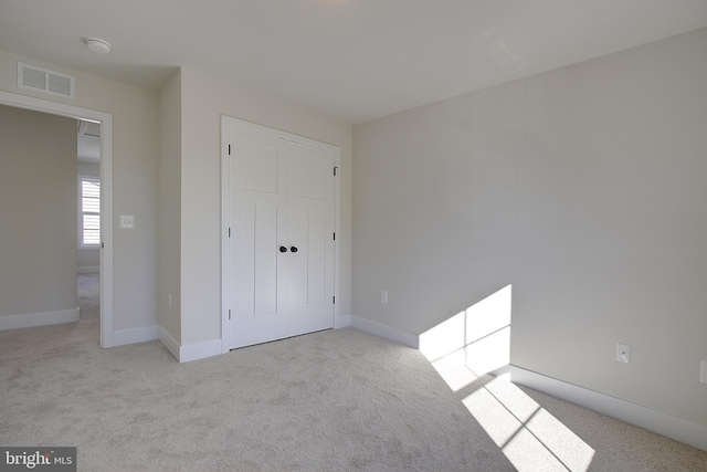 unfurnished bedroom with light colored carpet