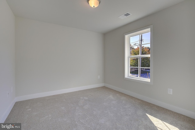 unfurnished room with light carpet