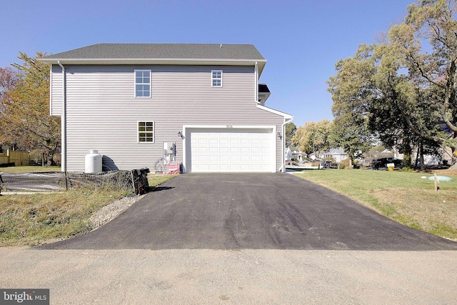 view of home's exterior with a lawn and a garage