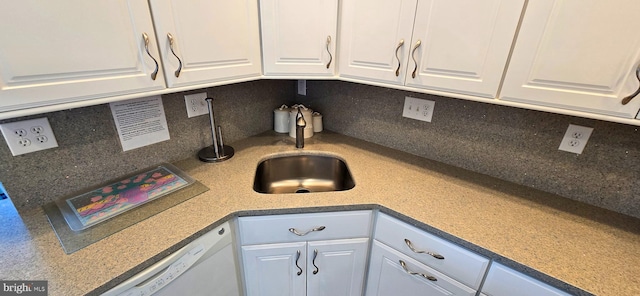 kitchen featuring white cabinets, decorative backsplash, sink, and white dishwasher