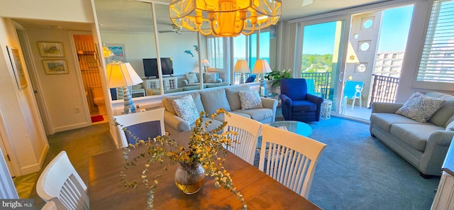 carpeted dining space with an inviting chandelier