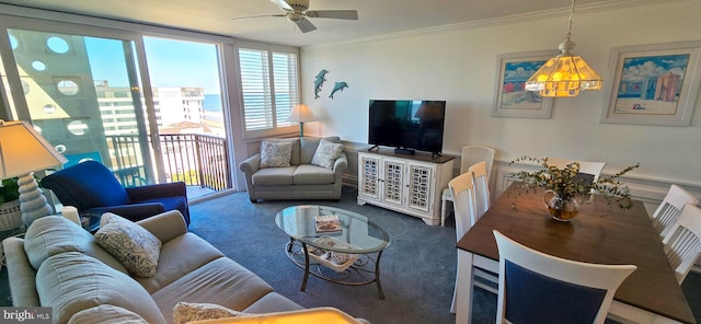 living room featuring ceiling fan, carpet, and ornamental molding