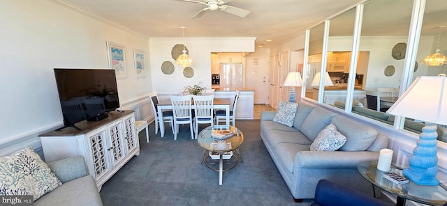 carpeted living room with ceiling fan and crown molding