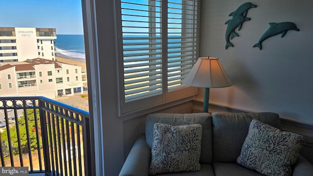 balcony featuring a water view and a beach view