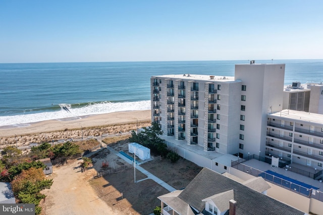 drone / aerial view with a water view and a beach view