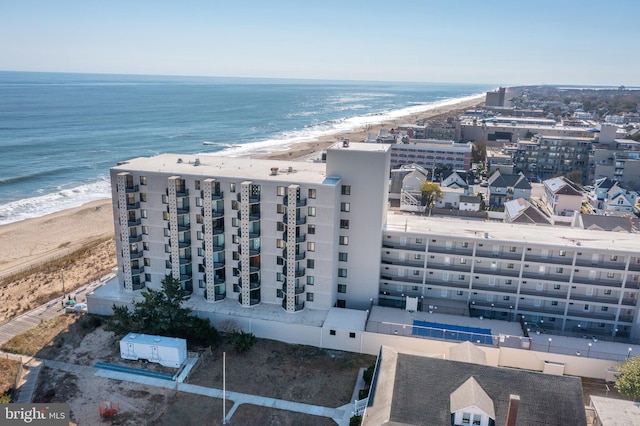 drone / aerial view with a beach view and a water view