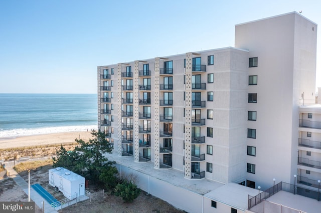 view of property with a water view and a view of the beach