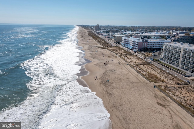 birds eye view of property with a water view and a beach view