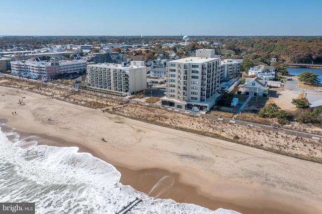 drone / aerial view featuring a water view and a view of the beach