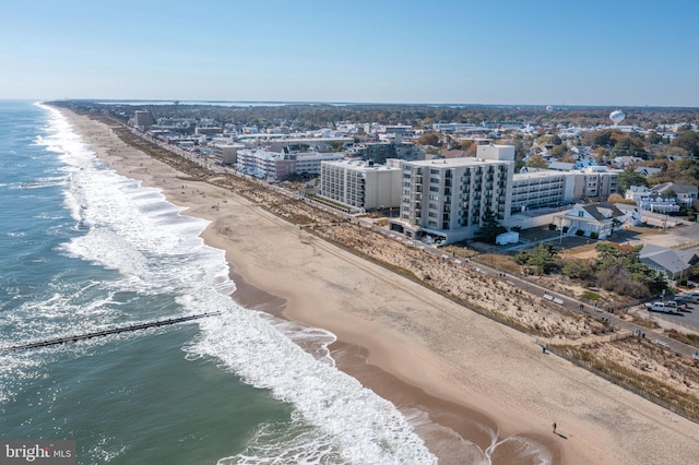 birds eye view of property with a water view and a view of the beach