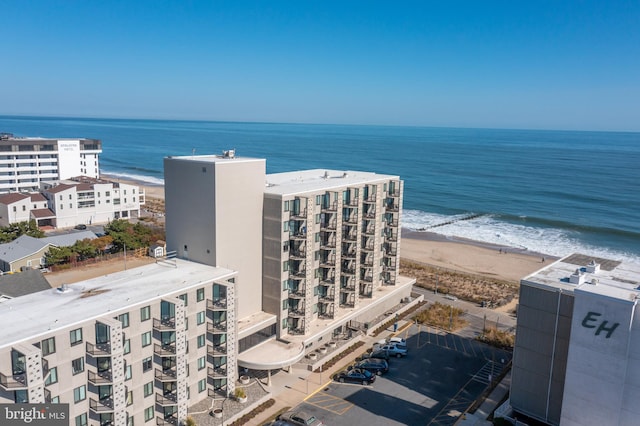 aerial view with a water view and a beach view