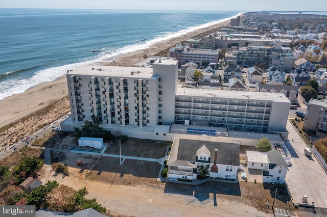 drone / aerial view featuring a view of the beach and a water view