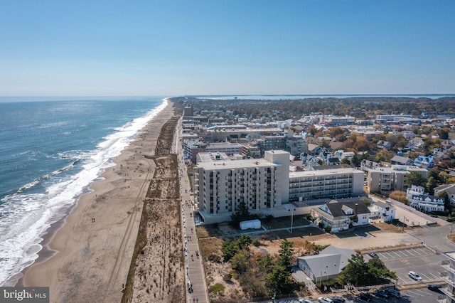 drone / aerial view featuring a water view and a view of the beach