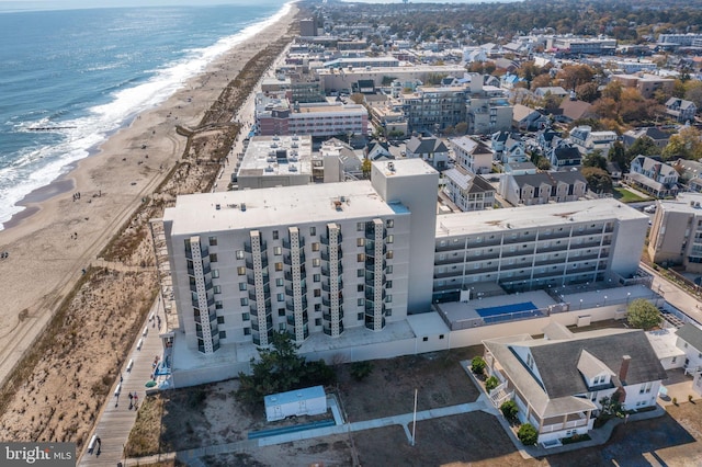 bird's eye view featuring a water view and a beach view