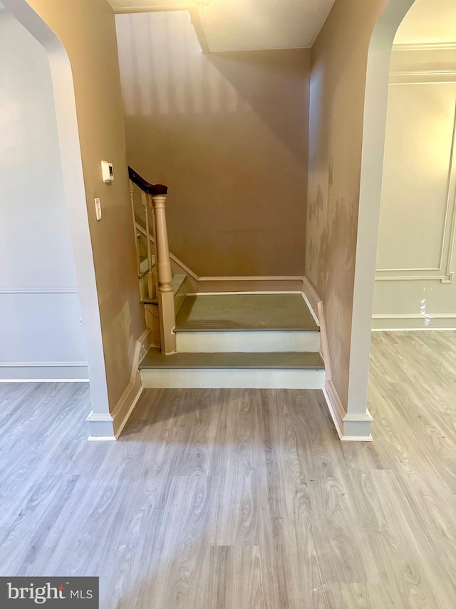 stairs featuring wood-type flooring