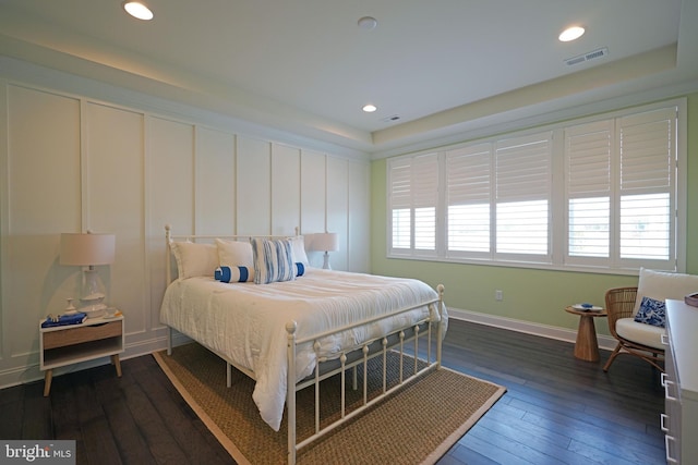 bedroom with dark hardwood / wood-style flooring