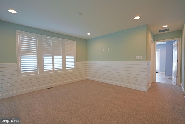 unfurnished room with light colored carpet