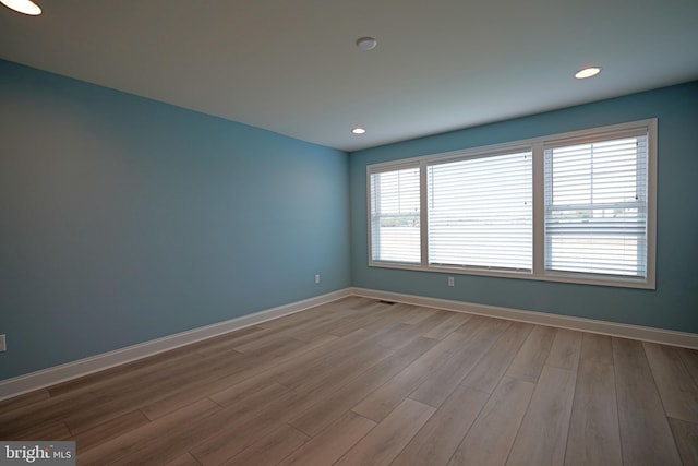 unfurnished room featuring light hardwood / wood-style floors and a healthy amount of sunlight