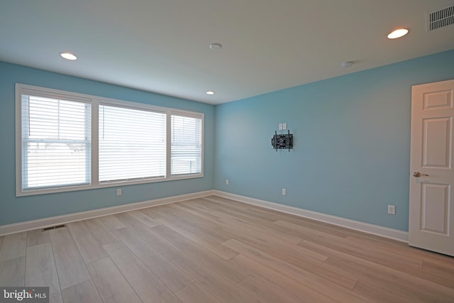 unfurnished room with a wealth of natural light and light hardwood / wood-style flooring