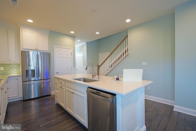 kitchen featuring white cabinetry, sink, a kitchen island with sink, and appliances with stainless steel finishes