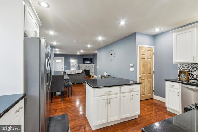 kitchen with white cabinetry, stainless steel appliances, and dark wood-type flooring