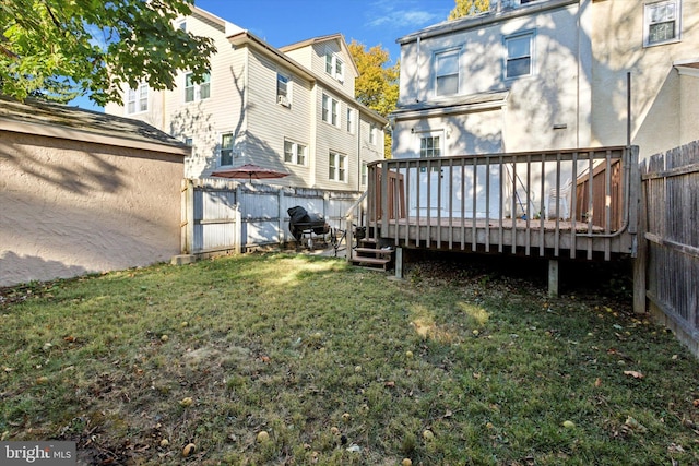 back of property featuring a yard and a wooden deck