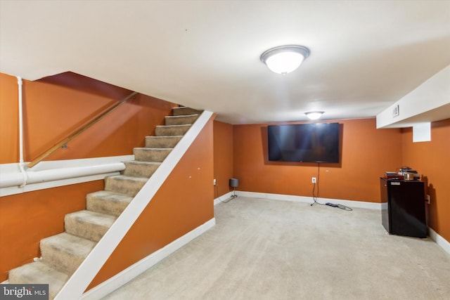 basement featuring light colored carpet