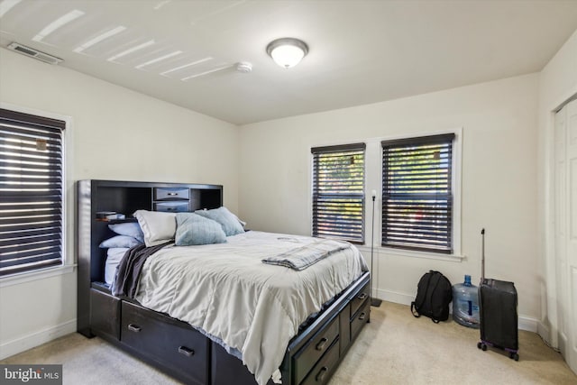 bedroom featuring light carpet