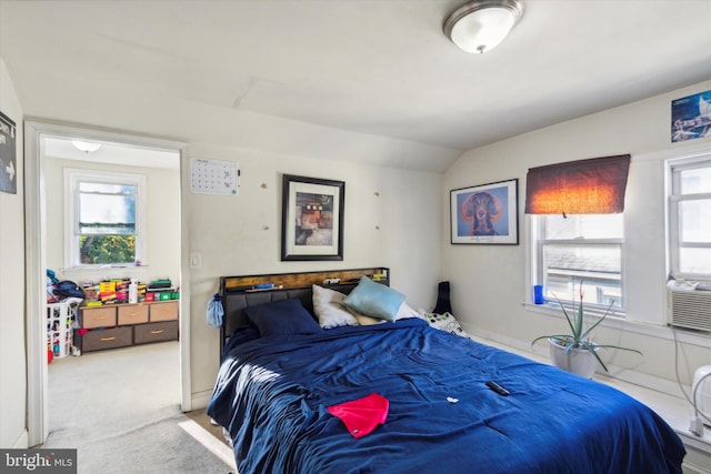 carpeted bedroom with lofted ceiling