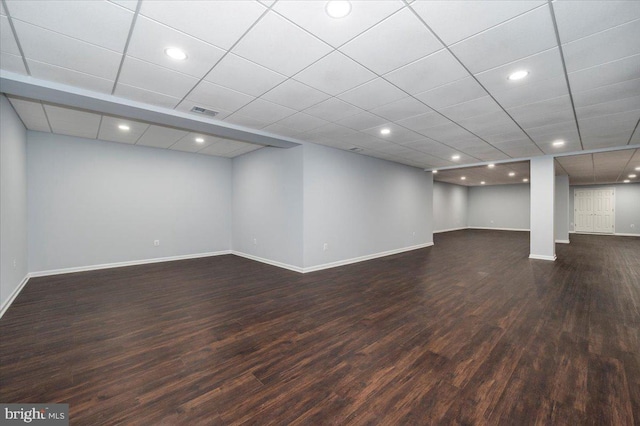 finished basement with baseboards, dark wood-style flooring, recessed lighting, and visible vents