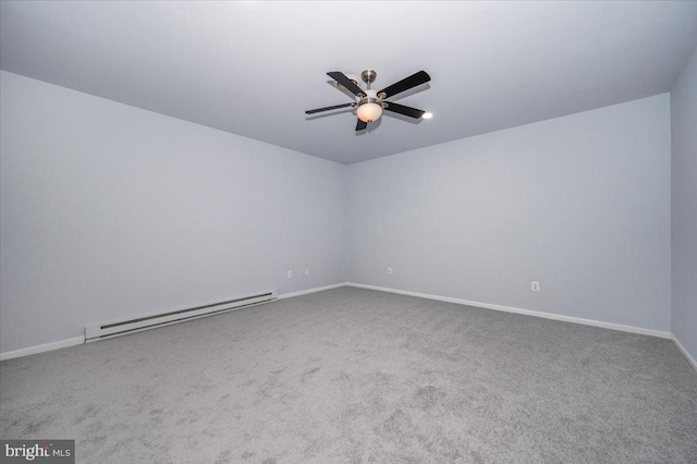 carpeted spare room featuring a baseboard heating unit, baseboards, and ceiling fan