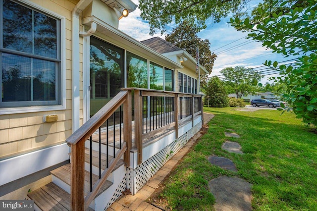 wooden terrace with a lawn