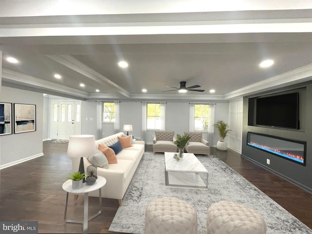 living area with a tray ceiling, baseboards, ceiling fan, crown molding, and dark wood-type flooring