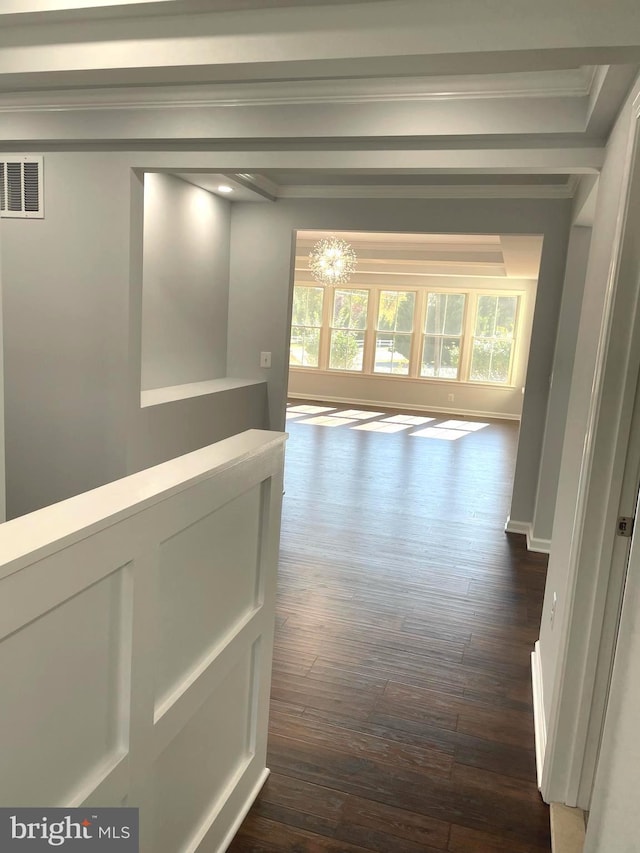 hallway featuring visible vents, crown molding, and dark wood-type flooring