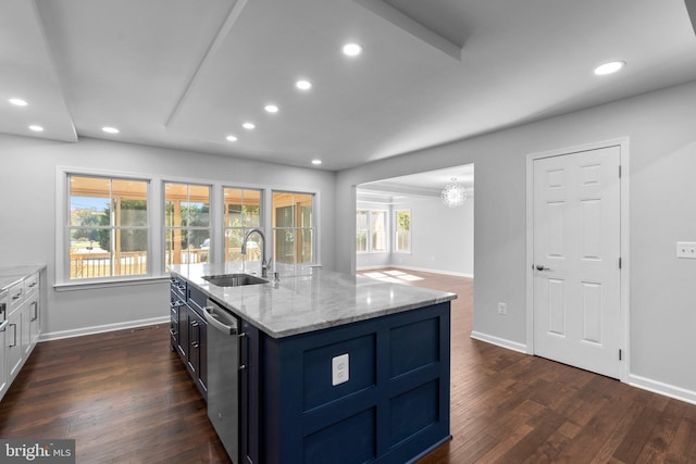 kitchen with dishwasher, sink, dark wood-type flooring, light stone counters, and an island with sink