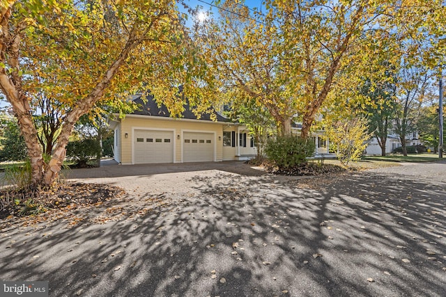 obstructed view of property with a garage