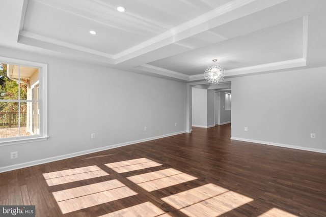 spare room with dark hardwood / wood-style flooring, a chandelier, and ornamental molding