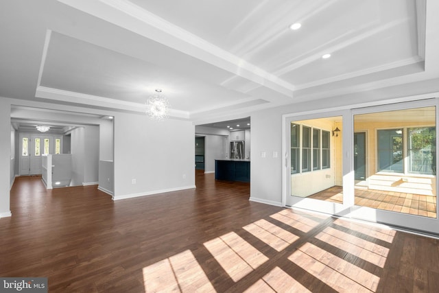 unfurnished living room featuring crown molding, a tray ceiling, a chandelier, and wood finished floors