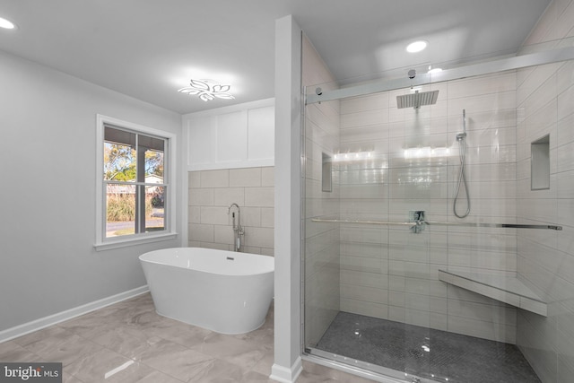 bathroom featuring shower with separate bathtub