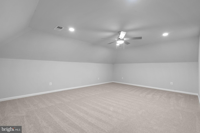 additional living space with ceiling fan, light colored carpet, and lofted ceiling