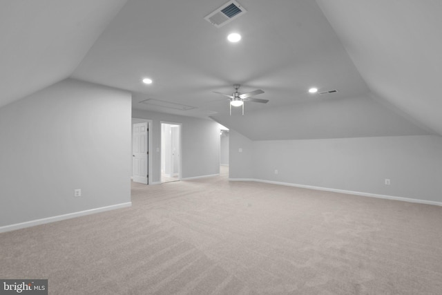 additional living space with light colored carpet, vaulted ceiling, and ceiling fan