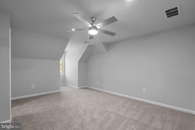 additional living space featuring light carpet, vaulted ceiling, and ceiling fan