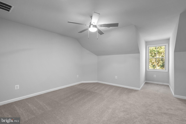 bonus room featuring lofted ceiling, visible vents, carpet flooring, a ceiling fan, and baseboards